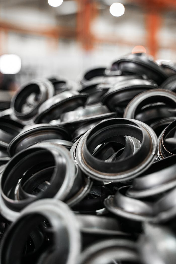 Mastering the First Impression: Your intriguing post title goes here Close-up of a pile of black metal rings in a manufacturing environment.
